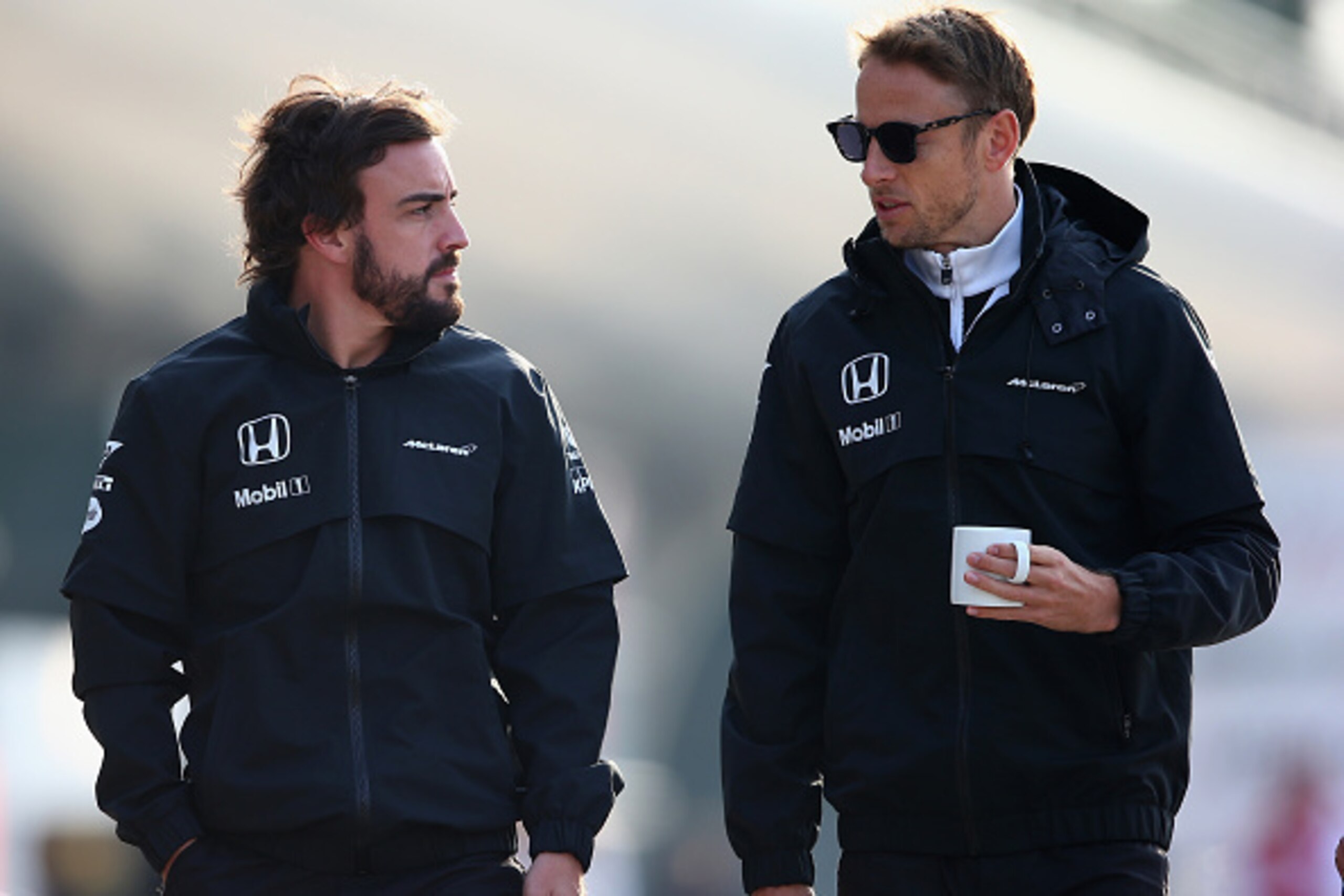 SHANGHAI, CHINA - APRIL 10:  Fernando Alonso of Spain and McLaren Honda and Jenson Button of Great Britain and McLaren Honda walk through the paddock during practice for the Formula One Grand Prix of China at Shanghai International Circuit on April 10, 20