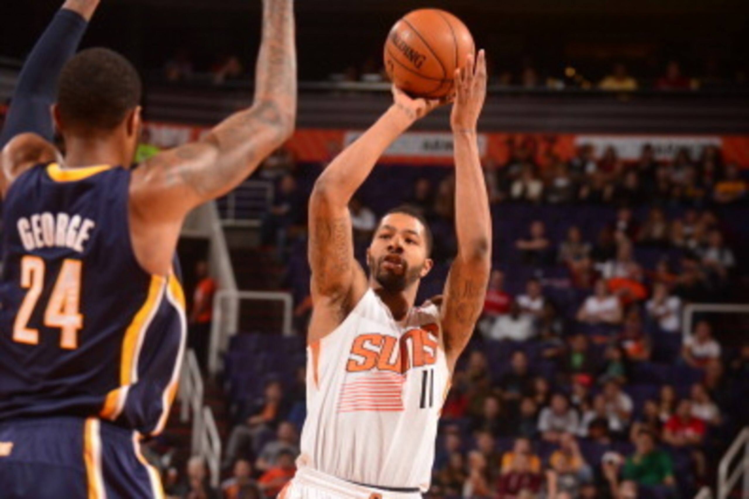 PHOENIX, AZ - JANUARY 22: Markieff Morris #11 of the Phoenix Suns shoots over Paul George #24 of the Indiana Pacers on January 22, 2014 at U.S. Airways Center in Phoenix, Arizona. NOTE TO USER: User expressly acknowledges and agrees that, by downloading a PHOENIX, AZ - JANUARY 22: Markieff Morris #11 of the Phoenix Suns shoots over Paul George #24 of the Indiana Pacers on January 22, 2014 at U.S. Airways Center in Phoenix, Arizona. NOTE TO USER: User expressly acknowledges and agrees that, by downloading a