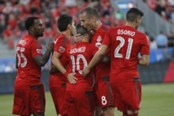 Aug 5, 2015; Toronto, Ontario, CAN; Toronto FC midfielder Benoit Cheyrou (8) and forward Robbie Findley (55) and midfielder Marco Delgado (18) and midfielder Jonathan Osorio (21) congratulate forward Sebastian Giovinco (10) after his goal against Orlando 