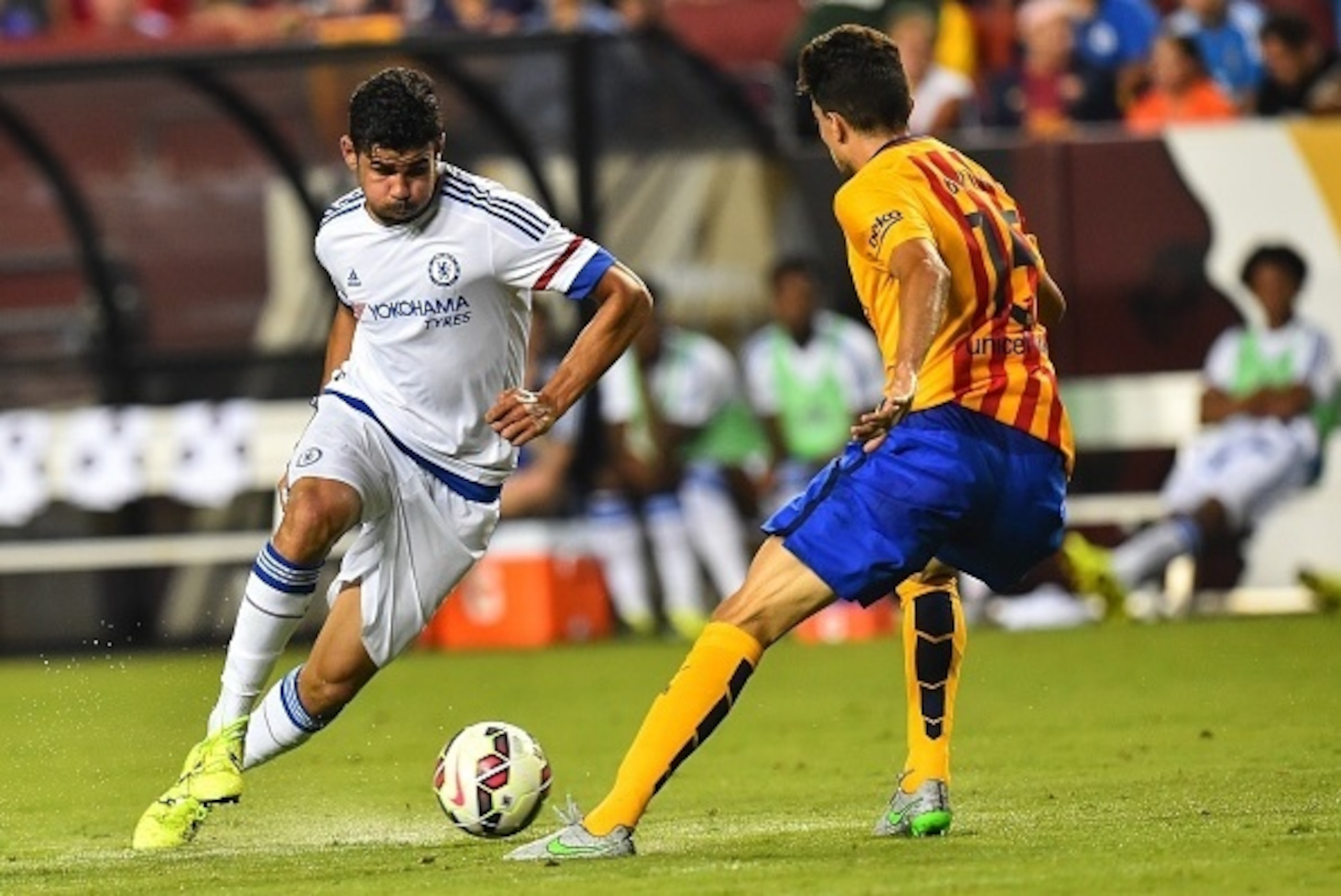 Chelsea's Diego Costa (L) vies with Barcelona's Marc Bartra during an International Champions Cup football match in Landover, Maryland, on July 28, 2015.    AFP PHOTO/NICHOLAS KAMM        (Photo credit should read NICHOLAS KAMM/AFP/Getty Images)