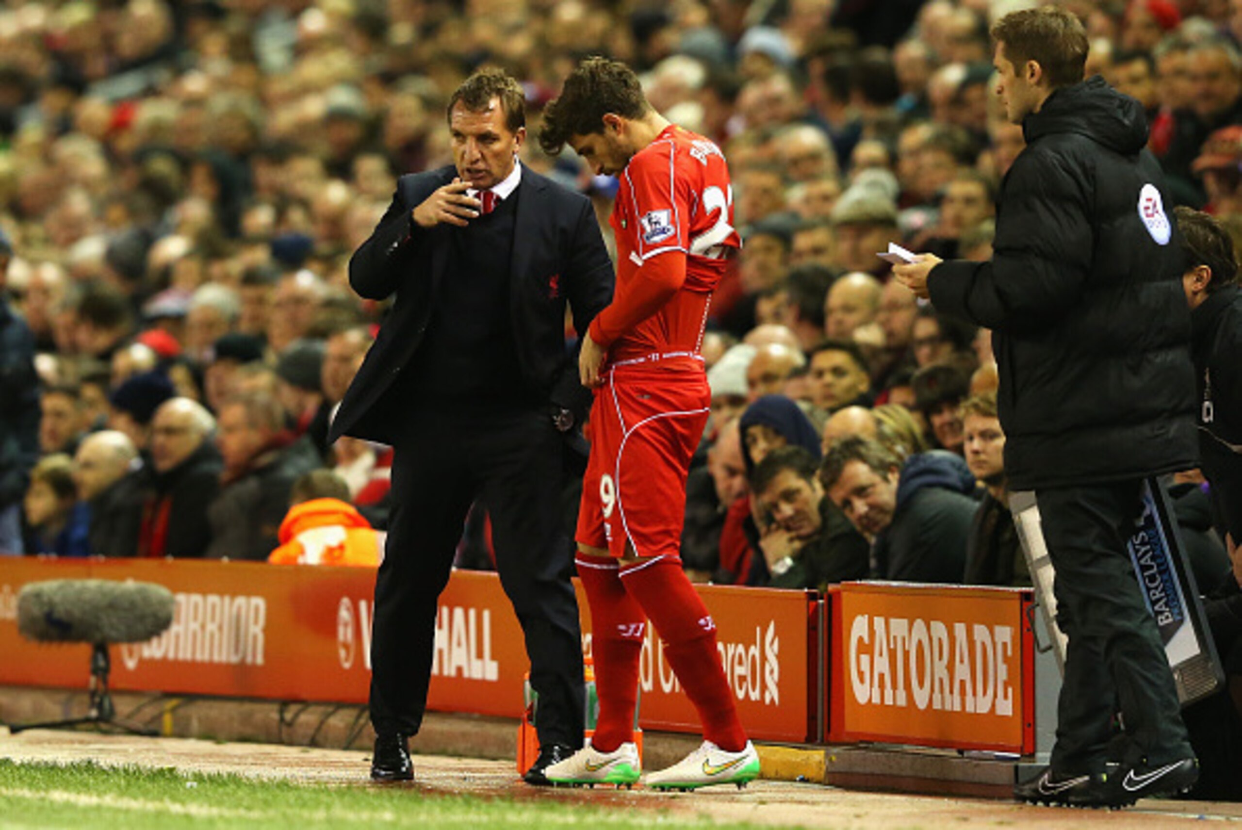 LIVERPOOL, ENGLAND - DECEMBER 21:  Brendan Rodgers, manager of Liverpool talks to Fabio Borini of Liverpool before he comes on as a substitute during the Barclays Premier League match between Liverpool and Arsenal at Anfield on December 21, 2014 in Liverp