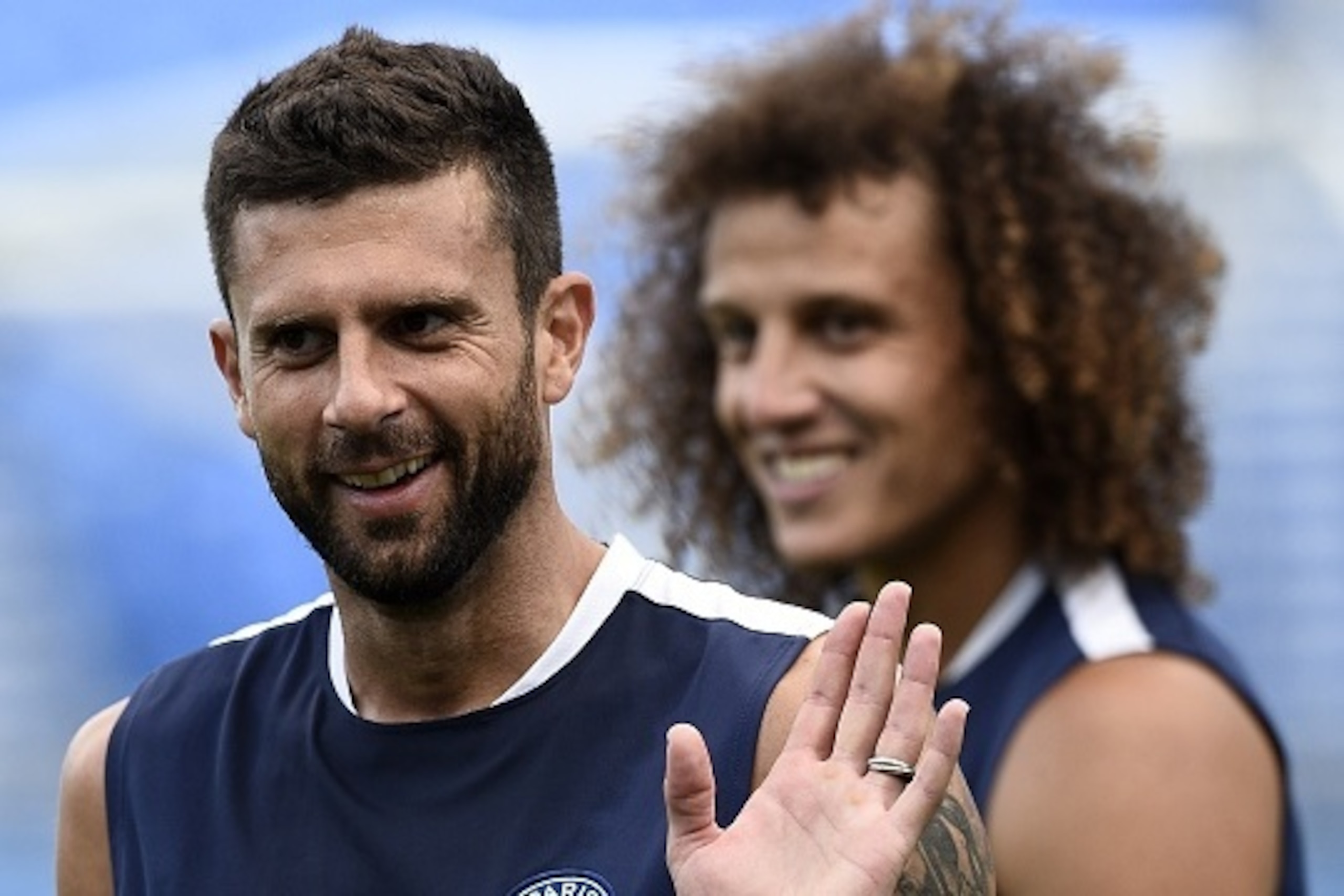 Paris Saint-Germain's Italian midfielder Thiago Motta (L) smiles next to Paris Saint-Germain's Brazilian defender David Luiz during a training session at Saputo stadium in Montreal on July 31, 2015 on the eve of the French Trophy of Champions football mat