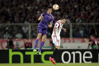 FLORENCE, ITALY - MAY 14: Stefan Savic of ACF Fiorentina battles for the ball with Vitolo of FC Sevilla during the UEFA Europa League Semi Final match between ACF Fiorentina and FC Sevilla on May 14, 2015 in Florence, Italy.  (Photo by Gabriele Maltinti/G