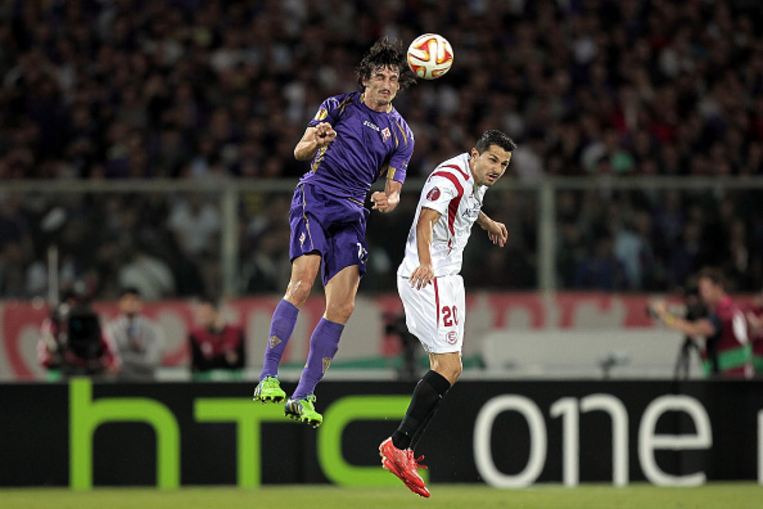 FLORENCE, ITALY - MAY 14: Stefan Savic of ACF Fiorentina battles for the ball with Vitolo of FC Sevilla during the UEFA Europa League Semi Final match between ACF Fiorentina and FC Sevilla on May 14, 2015 in Florence, Italy.  (Photo by Gabriele Maltinti/G