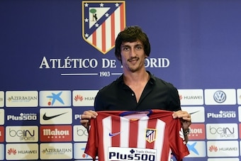 Atletico de Madrid's new football signing Montenegrin Stefan Savic poses with his new shirt during his presentation at Vicente Calderon stadium in Madrid on July 27, 2015.  AFP PHOTO / JAVIER SORIANO        (Photo credit should read JAVIER SORIANO/AFP/Get
