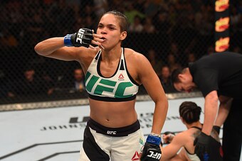 NASHVILLE, TN - AUGUST 08:  (L-R) Amanda Nunes of Brazil celebrates after defeating Sara McMann in their women's bantamweight bout during the UFC Fight Night event at Bridgestone Arena on August 8, 2015 in Nashville, Tennessee.  (Photo by Josh Hedges/Zuff