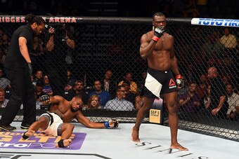 NASHVILLE, TN - AUGUST 08:  (R-L) Uriah Hall of Jamaica celebrates after finishing Oluwale Bamgbose by TKO in their middleweight bout during the UFC Fight Night event at Bridgestone Arena on August 8, 2015 in Nashville, Tennessee.  (Photo by Josh Hedges/Z