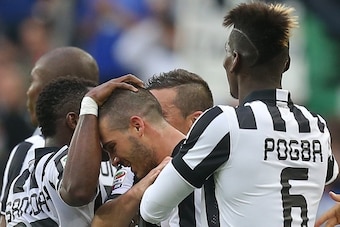Juventus' midfielder Stefano Sturaro (C) celebrates with teammates after scoring during the Italian Serie A football match Juventus vs Napoli on May 23, 2015 at the Juventus stadium in Turin.       AFP PHOTO / MARCO BERTORELLO        (Photo credit should 