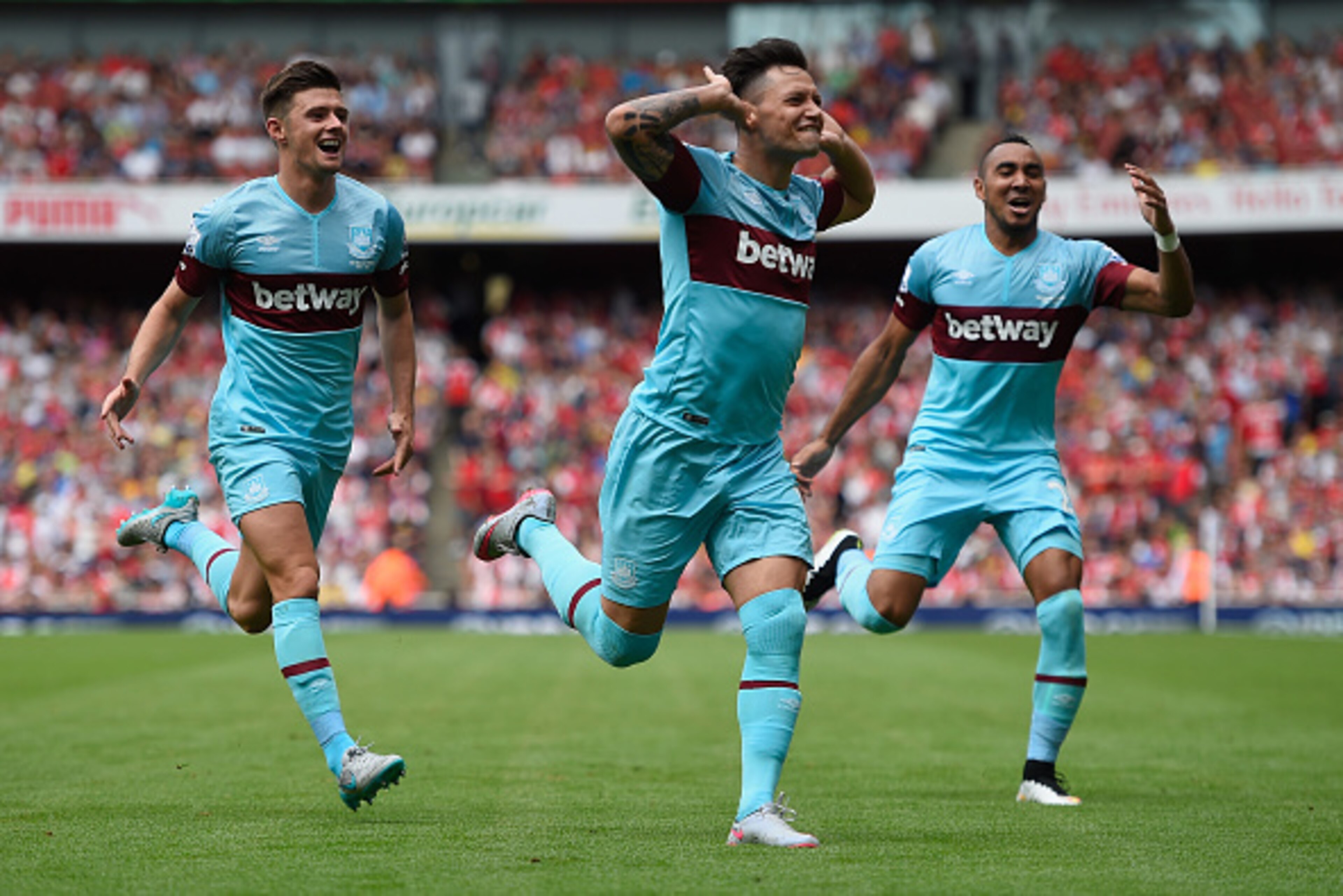 LONDON, ENGLAND - AUGUST 09:  Mauro Zarate of West Ham United (C) celebrates with team mates as he scores their second goal during the Barclays Premier League match between Arsenal and West Ham United at the Emirates Stadium on August 9, 2015 in London, E