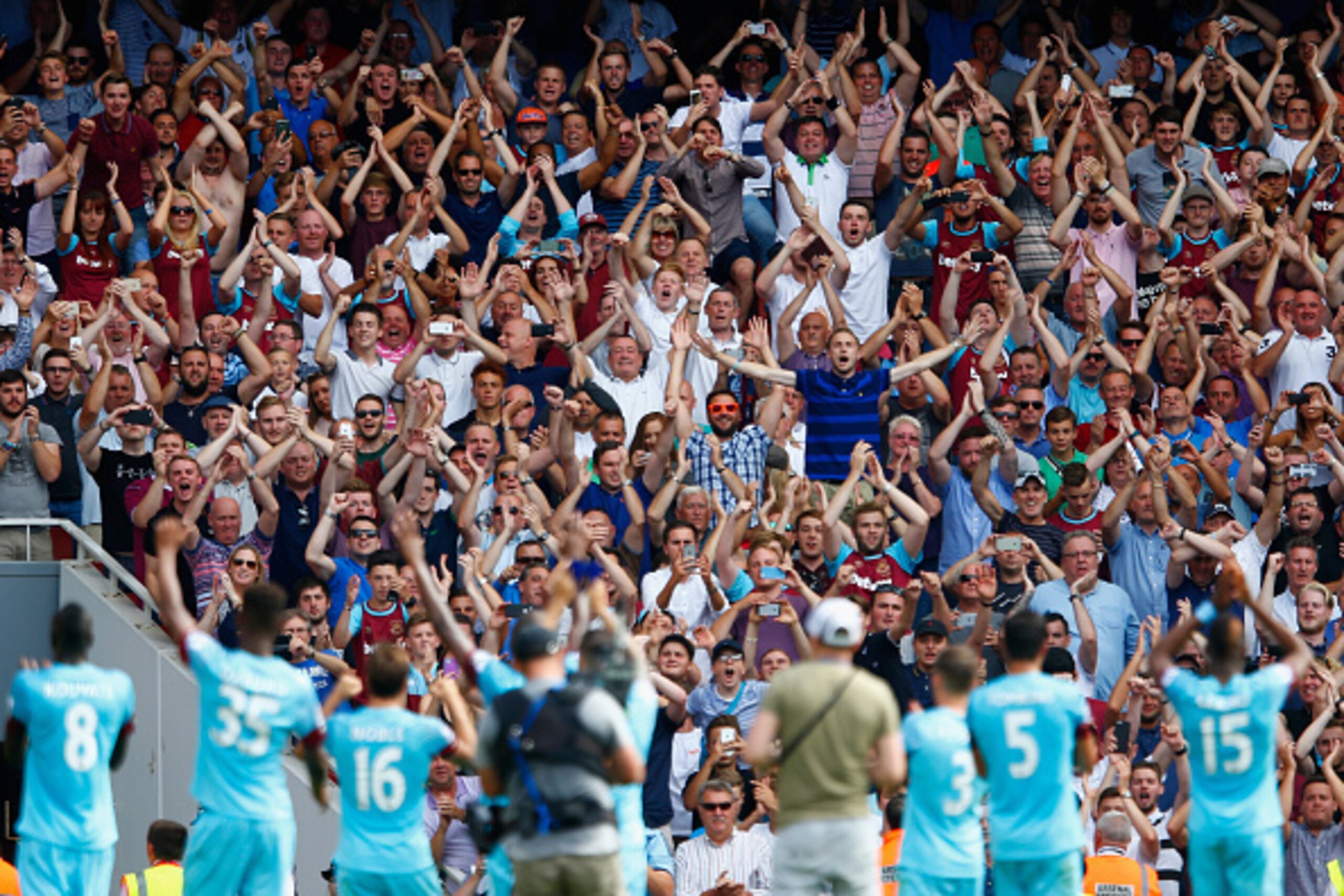 LONDON, ENGLAND - AUGUST 09:  West Ham players celebrate victory with fans after the Barclays Premier League match between Arsenal and West Ham United at the Emirates Stadium on August 9, 2015 in London, England.  (Photo by Julian Finney/Getty Images)