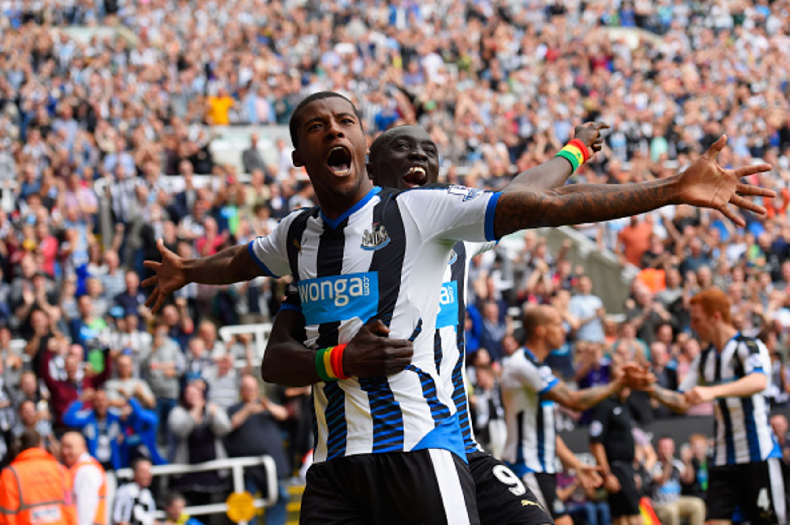 NEWCASTLE UPON TYNE, ENGLAND - AUGUST 09:  Georginio Wijnaldum of Newcastle United celebrates scoring their second goal with Papiss Demba Cisse of Newcastle United during the Barclays Premier League match between Newcastle United and Southampton at St Jam