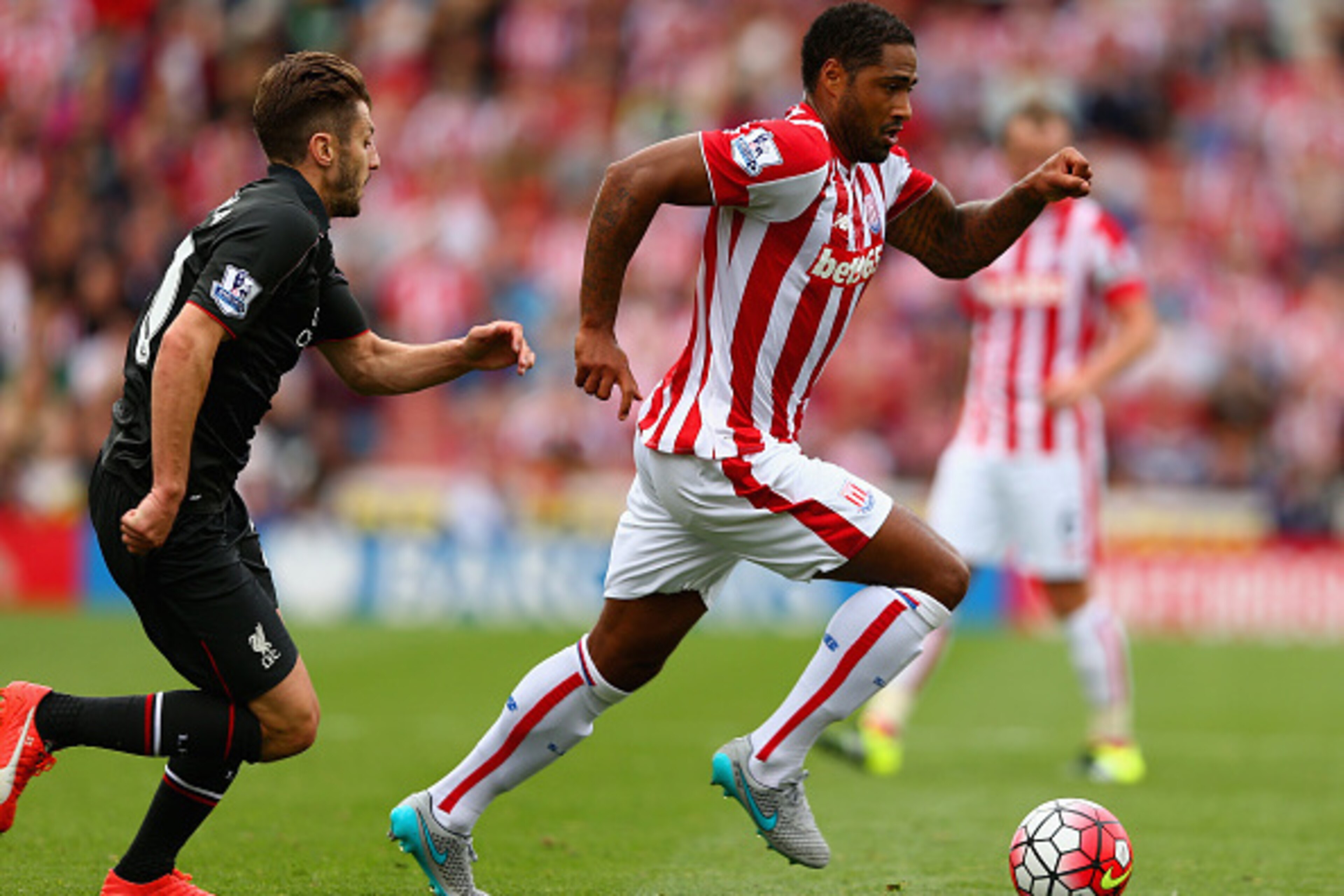 STOKE ON TRENT, ENGLAND - AUGUST 09: Glen Johnson of Stoke City holds off Adam Lallana of Liverpool during the Barclays Premier League match between Stoke City and Liverpool at Brittania Stadium on August 9, 2015 in Stoke on Trent, England. (Photo by Cl STOKE ON TRENT, ENGLAND - AUGUST 09: Glen Johnson of Stoke City holds off Adam Lallana of Liverpool during the Barclays Premier League match between Stoke City and Liverpool at Brittania Stadium on August 9, 2015 in Stoke on Trent, England. (Photo by Cl