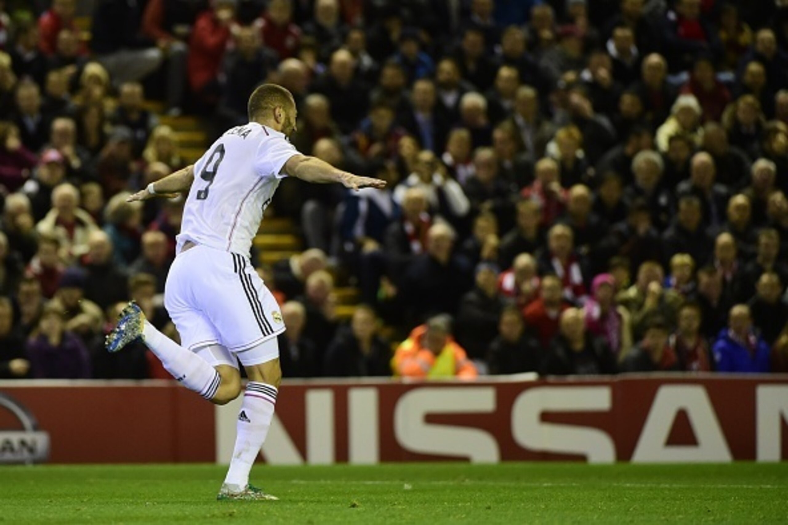 Real Madrid's French forward Karim Benzema (L) celebrates scoring Real Madrid's second goal during the UEFA Champions League, group B, football match between Liverpool and Real Madrid at Anfield in Liverpool, northwest England, on October 22, 2014. AFP PH