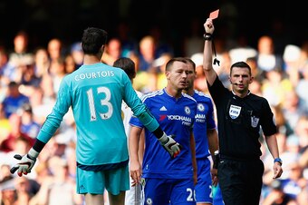 LONDON, ENGLAND - AUGUST 08:  Thibaut Courtois (L) of Chelsea is shown the red card by referee Michael Oliver (R) during the Barclays Premier League match between Chelsea and Swansea City at Stamford Bridge on August 8, 2015 in London, England.  (Photo by