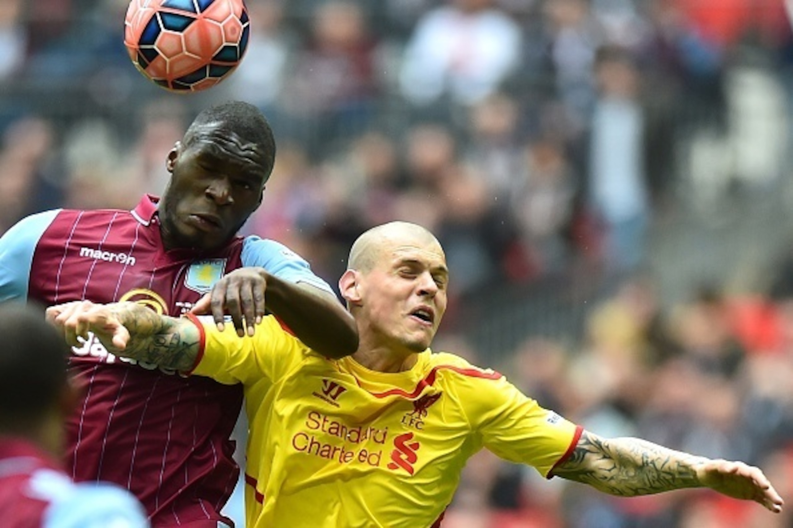 Aston Villa's Zaire-born Belgian striker Christian Benteke (L) heads the ball with Liverpool's Slovakian defender Martin Skrtel during the FA Cup semi-final between Aston Villa and Liverpool at Wembley stadium in London on April 19, 2015.
AFP PHOTO / BEN 