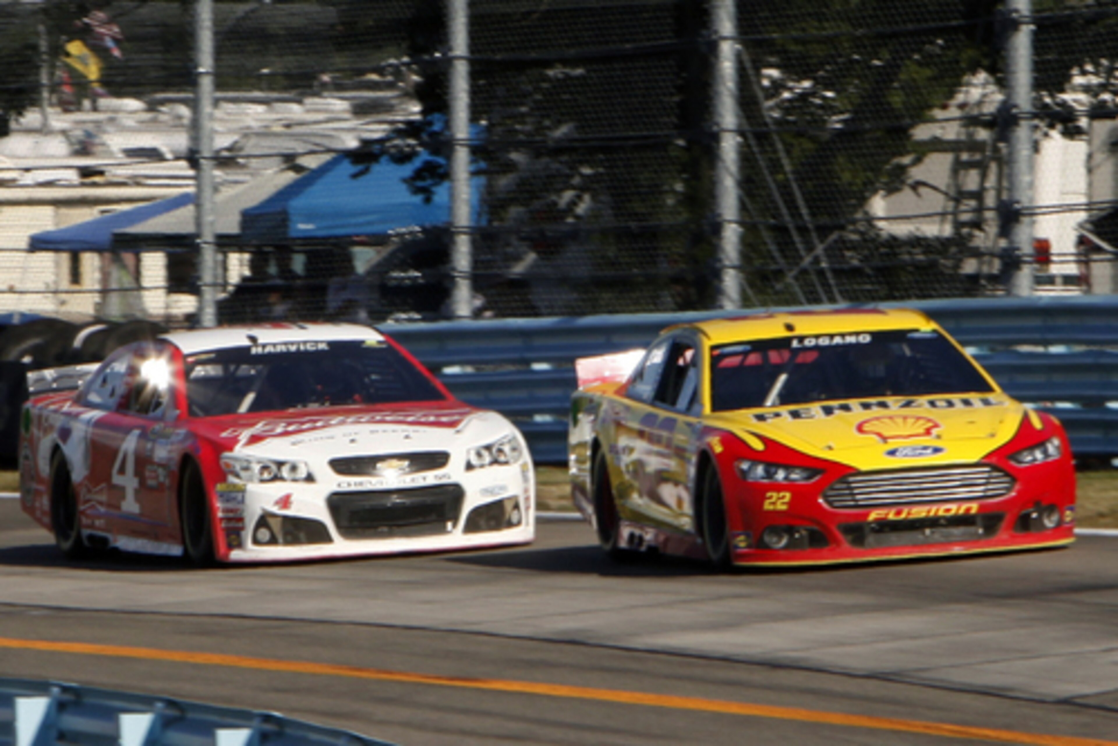 Joey Logano passes Kevin Harvick on the final lap.