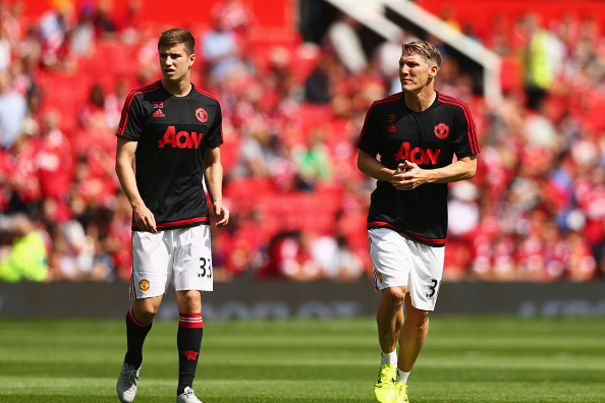MANCHESTER, ENGLAND - AUGUST 08: Paddy McNair and Bastian Schweinsteiger of Manchester United warm up prior to the Barclays Premier League match between Manchester United and Tottenham Hotspur at Old Trafford on August 8, 2015 in Manchester, England.  (Ph