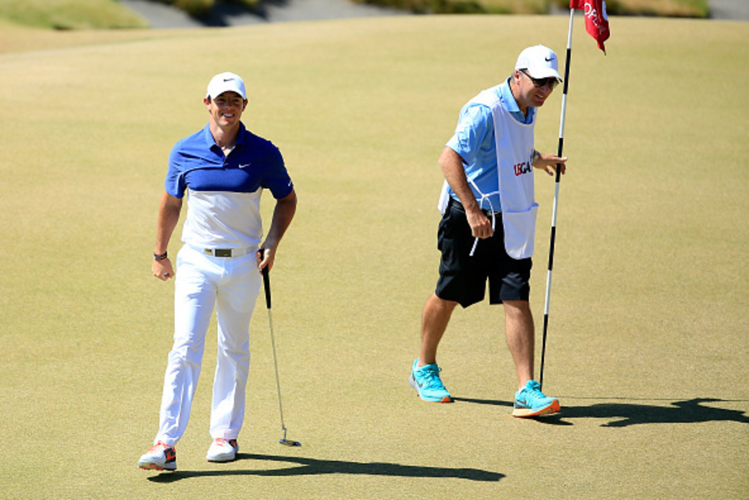 UNIVERSITY PLACE, WA - JUNE 21: Rory McIlroy of Northern Ireland smiles on the 13th green as caddie J.P. Fitzgerald looks on during the final round of the 115th U.S. Open Championship at Chambers Bay on June 21, 2015 in University Place, Washington.  (Pho