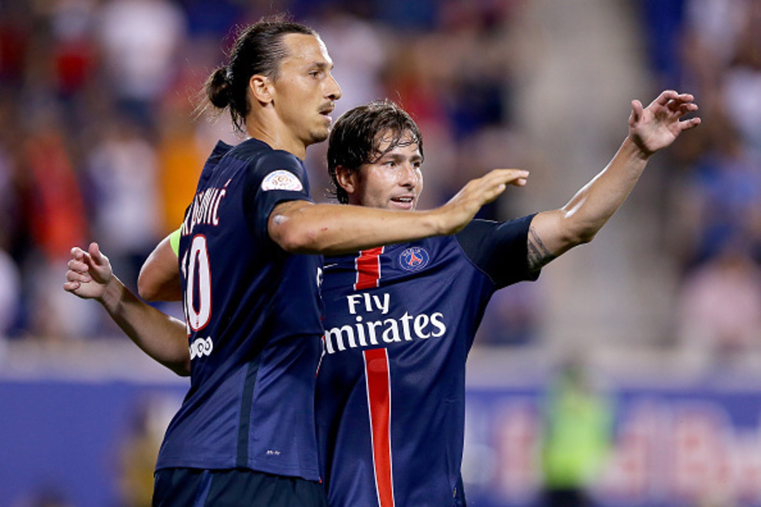 HARRISON, NJ - JULY 21:  Zlatan Ibrahimovic #10 of Paris Saint-Germain is congratulated by teamamte Maxwell #17 after Ibrahimovic scored a goal in the second half against AFC Fiorentina during the International Champions Cup at Red Bull Arena on July 21,