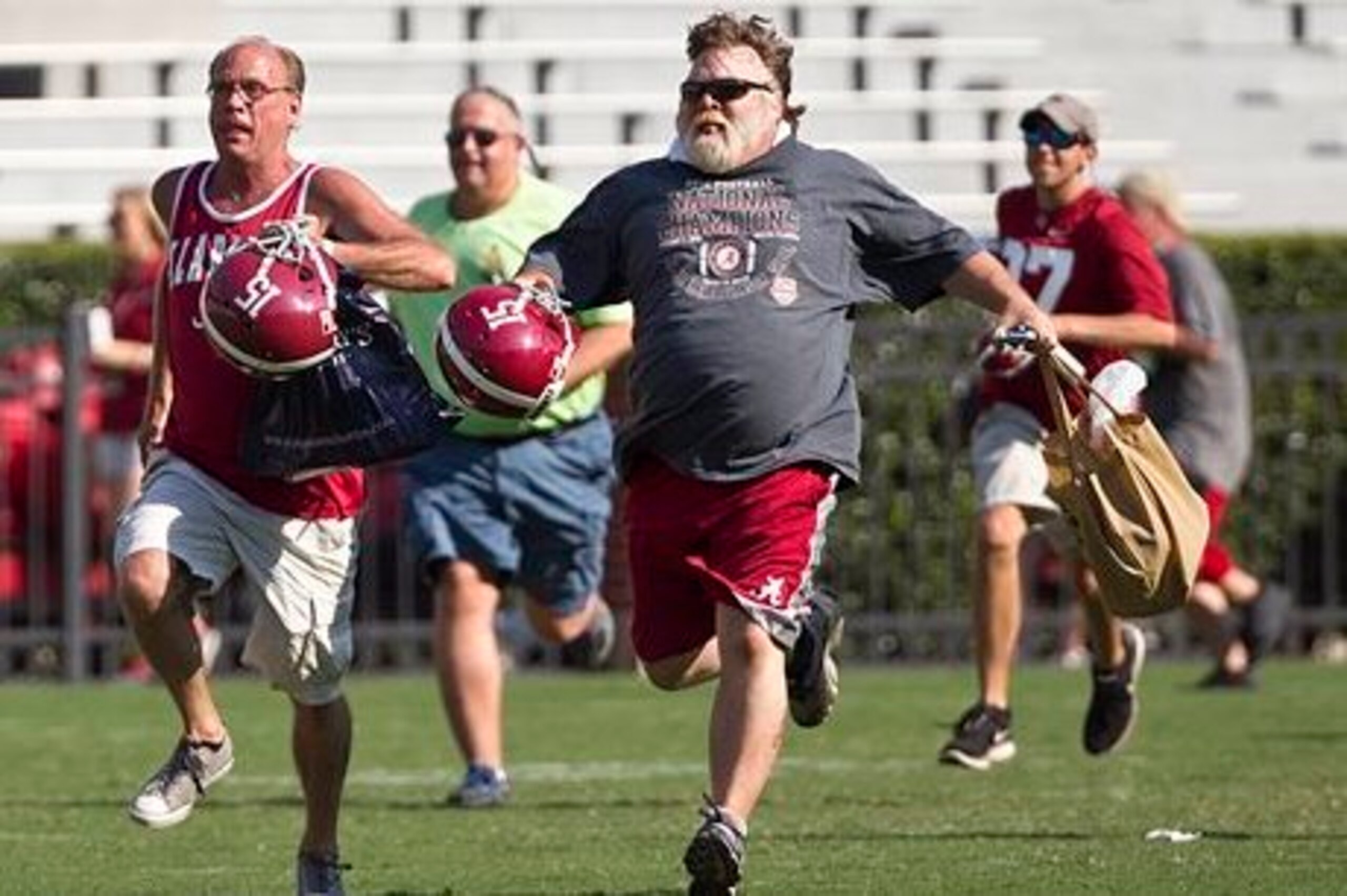 These fans weren't racing to get the unauthorized copy of Nick Saban's book, rather his autograph at Alabama's fan day on Sunday.