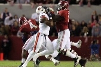 Nov 29, 2014; Tuscaloosa, AL, USA; Alabama Crimson Tide offensive lineman Cam Robinson (74) battles Auburn Tigers defensive lineman LaDarius Owens (10) in the third quarter at Bryant-Denny Stadium. Mandatory Credit: Marvin Gentry-USA TODAY Sports