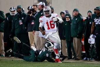 EAST LANSING, MI - NOVEMBER 8: J.T. Barrett #16 of the Ohio State Buckeyes runs for a 55-yard gain against the Michigan State Spartans during the game at Spartan Stadium on November 8, 2014 in East Lansing, Michigan. Ohio State defeated Michigan State 49-