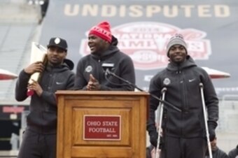 Jan 24, 2015; Columbus, OH, USA; Ohio State Buckeyes quarterback Cardale Jones (12) addresses the fans as fellow quarterbacks Braxton Miller (5) and J.T. Barrett (16) listen during the National Championship celebration at Ohio Stadium. Mandatory Credit: G