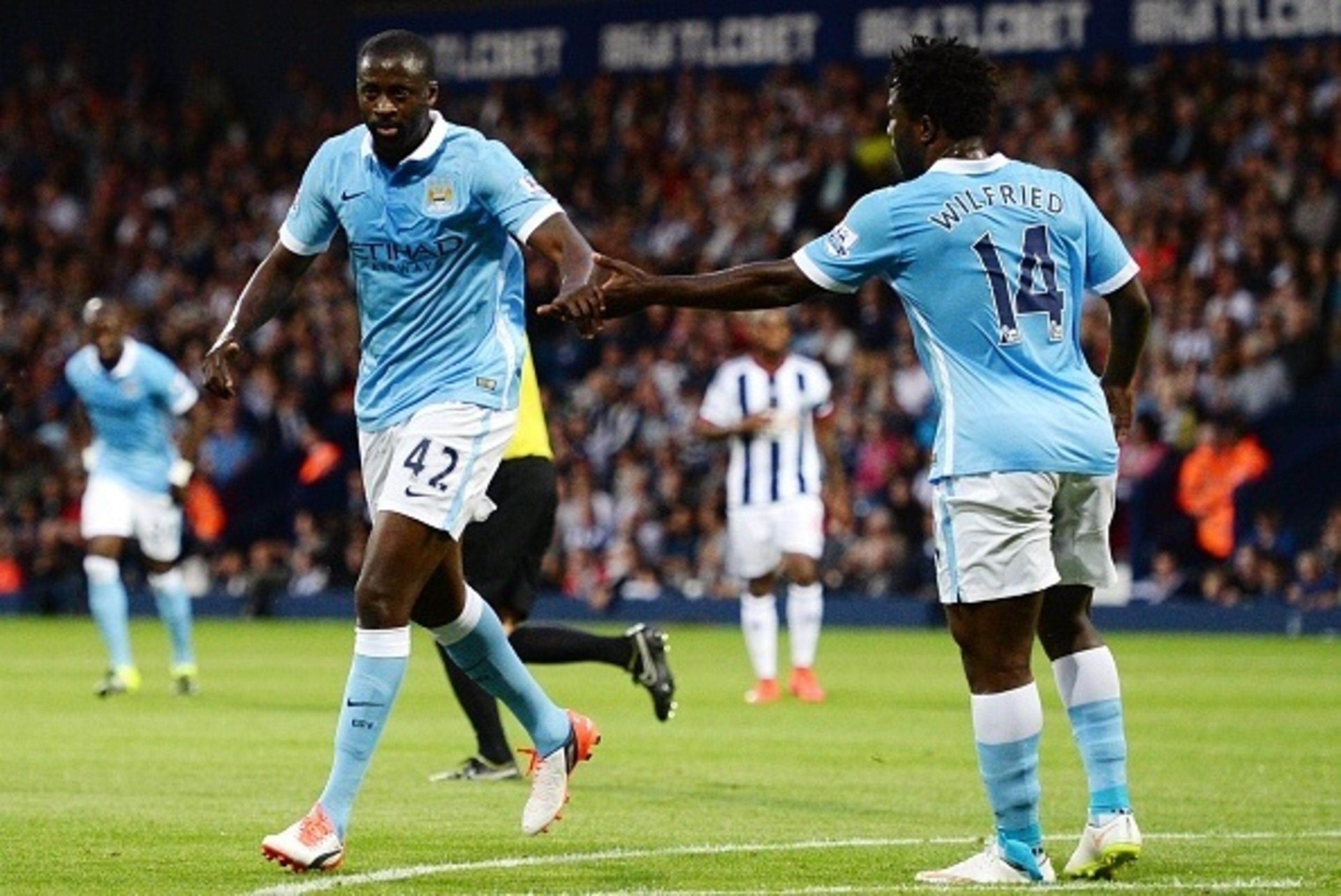 Manchester City's Ivorian midfielder Yaya Toure (L) celebrates with Manchester City's Ivorian striker Wilfried Bony after scoring his second goal during the English Premier League football match between West Bromwich Albion and Manchester City at The Hawt