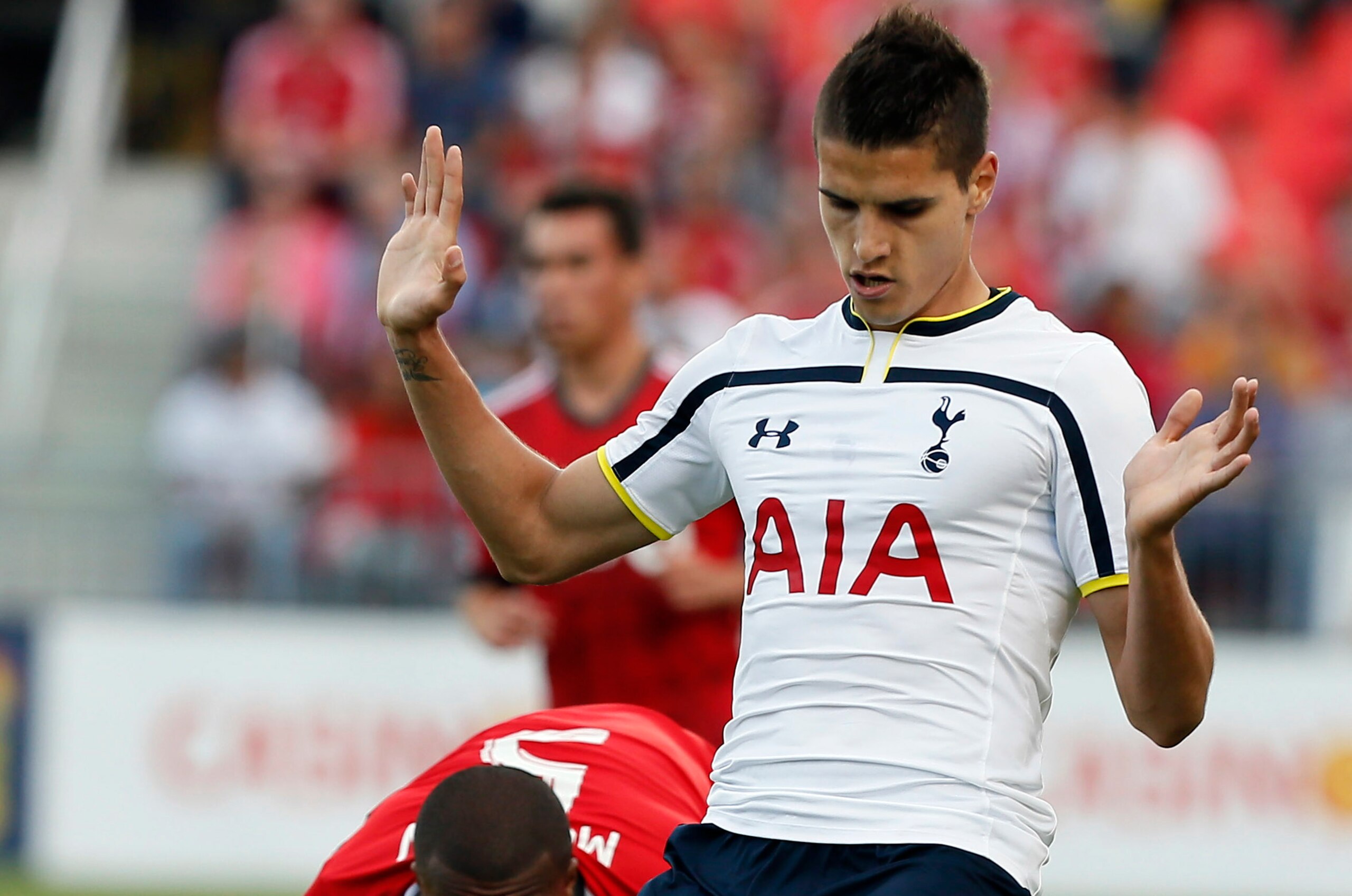 Jul 23, 2014; Toronto, Ontario, Canada; Tottenham Hotspur midfielder Erik Lamela (11) controls the ball against Toronto FC defender Ashtone Morgan (5) during the first half at BMO Field. Mandatory Credit: John E. Sokolowski-USA TODAY Sports