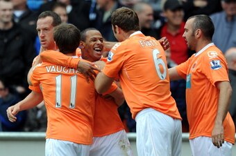 BLACKPOOL, ENGLAND - MAY 14:  DJ Campbell of Blackpool is congratulated by his team-mates after scoring the opening goal during the Barclays Premier League match between Blackpool and Bolton Wanderers at Bloomfield Road on May 14, 2011 in Blackpool, Engla