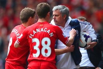 LIVERPOOL, ENGLAND - APRIL 27: (EDITORS NOTE: Retransmission of image 487057275 with alternate crop.) Steven Gerrard and Jon Flanagan of Liverpool have words with Jose Mourinho manager of Chelsea as he holds onto the ball during the Barclays Premier Leagu