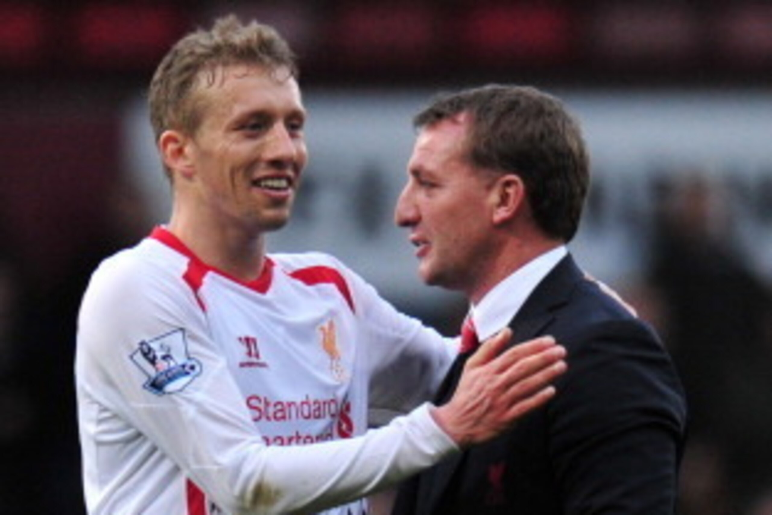 Liverpool's Northern Irish manager Brendan Rodgers (R) greets Liverpool's Brazilian midfielder Lucas Leiva (L) at the end of the English Premier League football match between West Ham United and Liverpool at Upton Park in London on April 6, 2014. Liverpoo