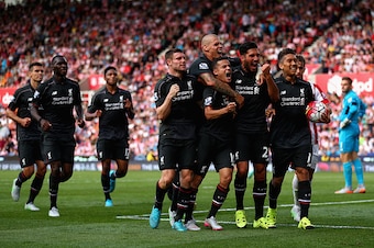 STOKE ON TRENT, ENGLAND - AUGUST 09:  Philippe Coutino of Liverpool celebrates after scoring the winning goal with team mates Emre Can,Roberto Firmino and James Milner during the Barclays Premier League match between Stoke City and Liverpool at Britannia 