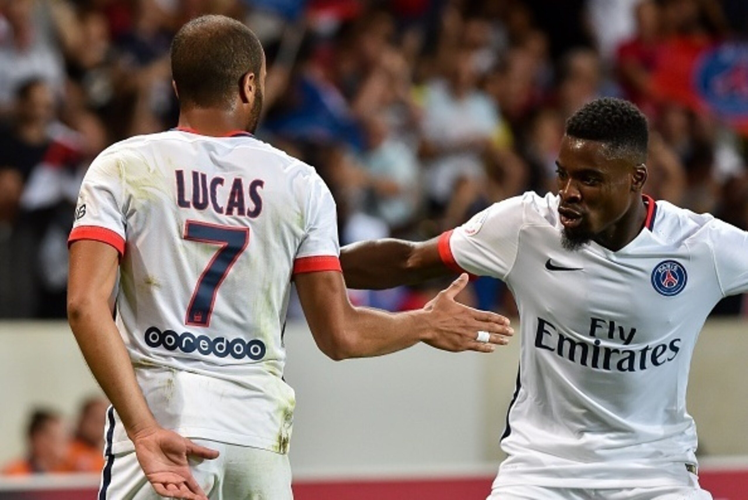 Paris Saint-Germain's Brazilian midfielder Lucas (L) celebrates his goal with teammate French defender Serge Aurier during the French L1 football match between Lille and  PSG on August 7, 2015 at the Pierre Mauroy Stadium in Villeneuve d'Ascq. AFP PHOTO /