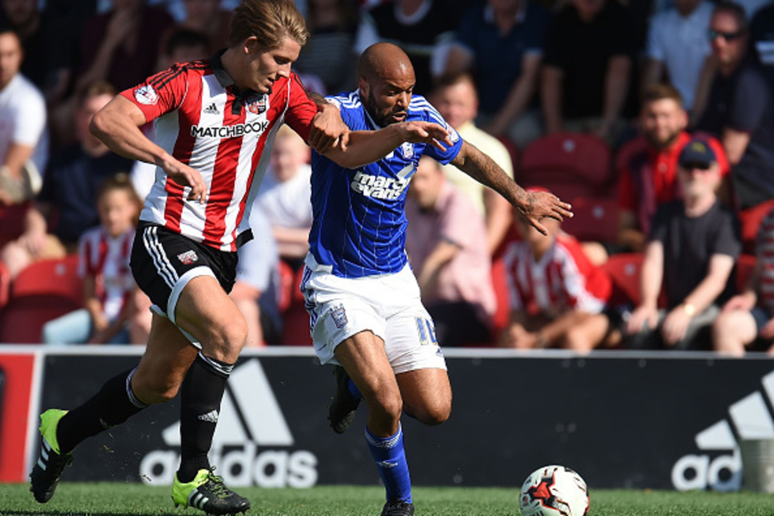 BRENTFORD, ENGLAND - AUGUST 08: James Tarkowski of Brentford and David McGoldrick of Ipswich Town in action during the Sky Bet Championship match between Brentford and Ipswich Town at Griffin Park on August 8, 2015 in Brentford, England. (Photo by Tom Dul