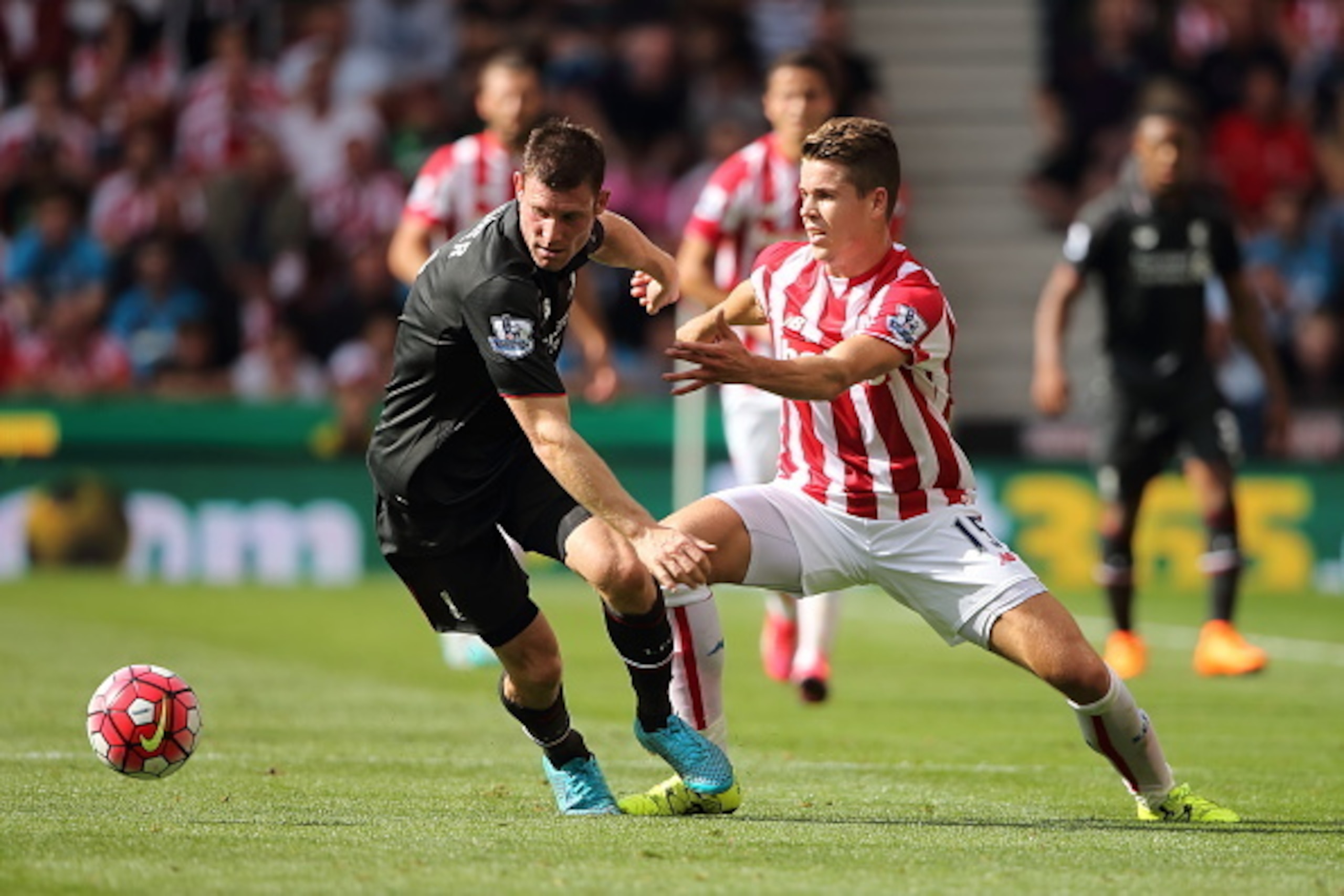 STOKE, ENGLAND - AUGUST 09:  James Milner of Liverpool and Marco van Ginkel of Stoke City during the Barclays Premier League match between Stoke City and Liverpool at the Britannia Stadium on August 09, 2015 in Stoke, England.  (Photo by Matthew Ashton - 