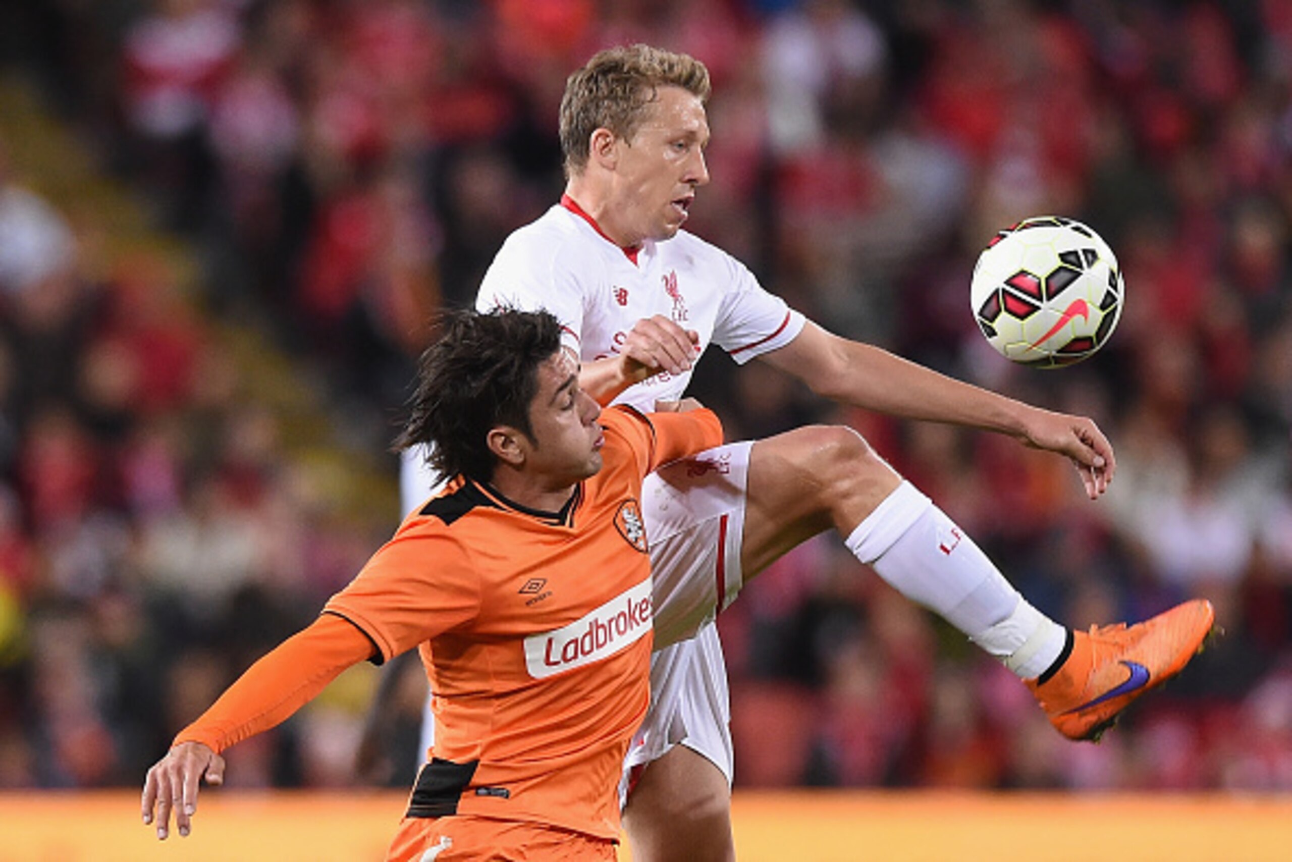 BRISBANE, AUSTRALIA - JULY 17:  Lucas Leiva of Liverpool FC and Dimitri Petratos of Brisbane Roar compete for the ball during the international friendly match between Brisbane Roar and Liverpool FC at Suncorp Stadium on July 17, 2015 in Brisbane, Australi