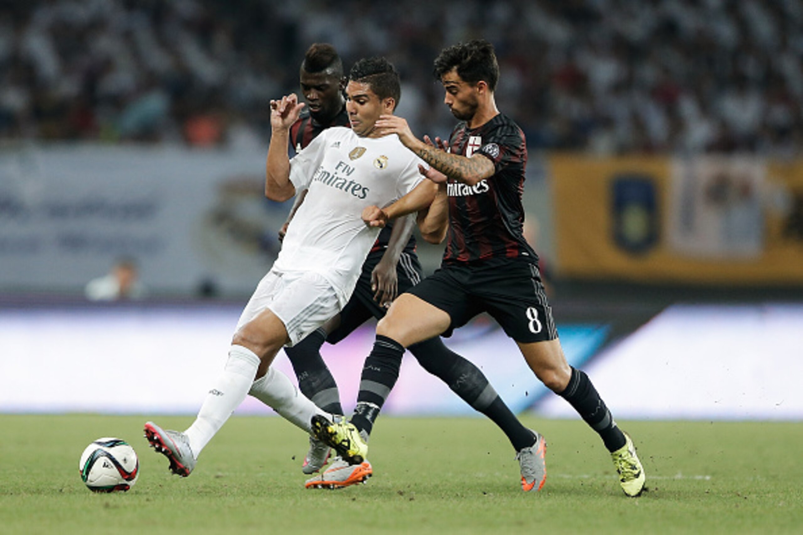 SHANGHAI, CHINA - JULY 30:  Casemiro (C) of Real Madrid contests the ball against Suso (R) and Niang M'baye Hamady of AC Milan during the International Champions Cup match between Real Madrid and AC Milan at Shanghai Stadium on July 30, 2015 in Shanghai, 