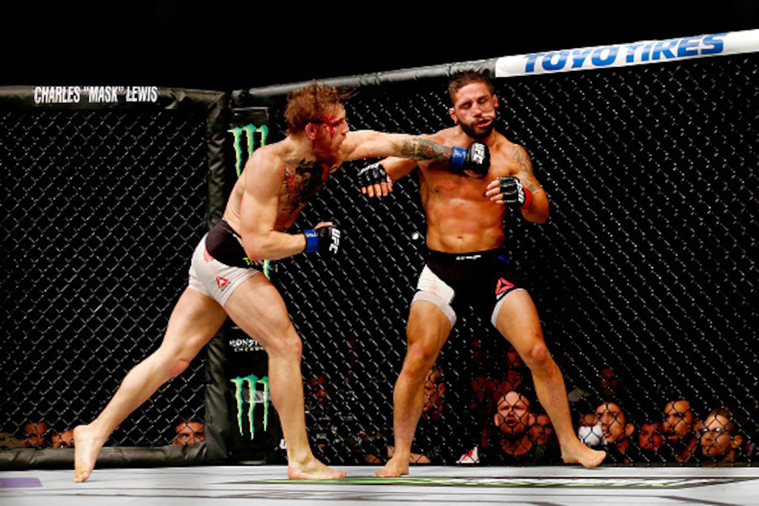 LAS VEGAS, NV - JULY 11:  (L-R) Conor McGregor punches Chad Mendes in their UFC interim featherweight title fight during the UFC 189 event inside MGM Grand Garden Arena on July 11, 2015 in Las Vegas, Nevada.  (Photo by Christian Petersen/Zuffa LLC/Zuffa L