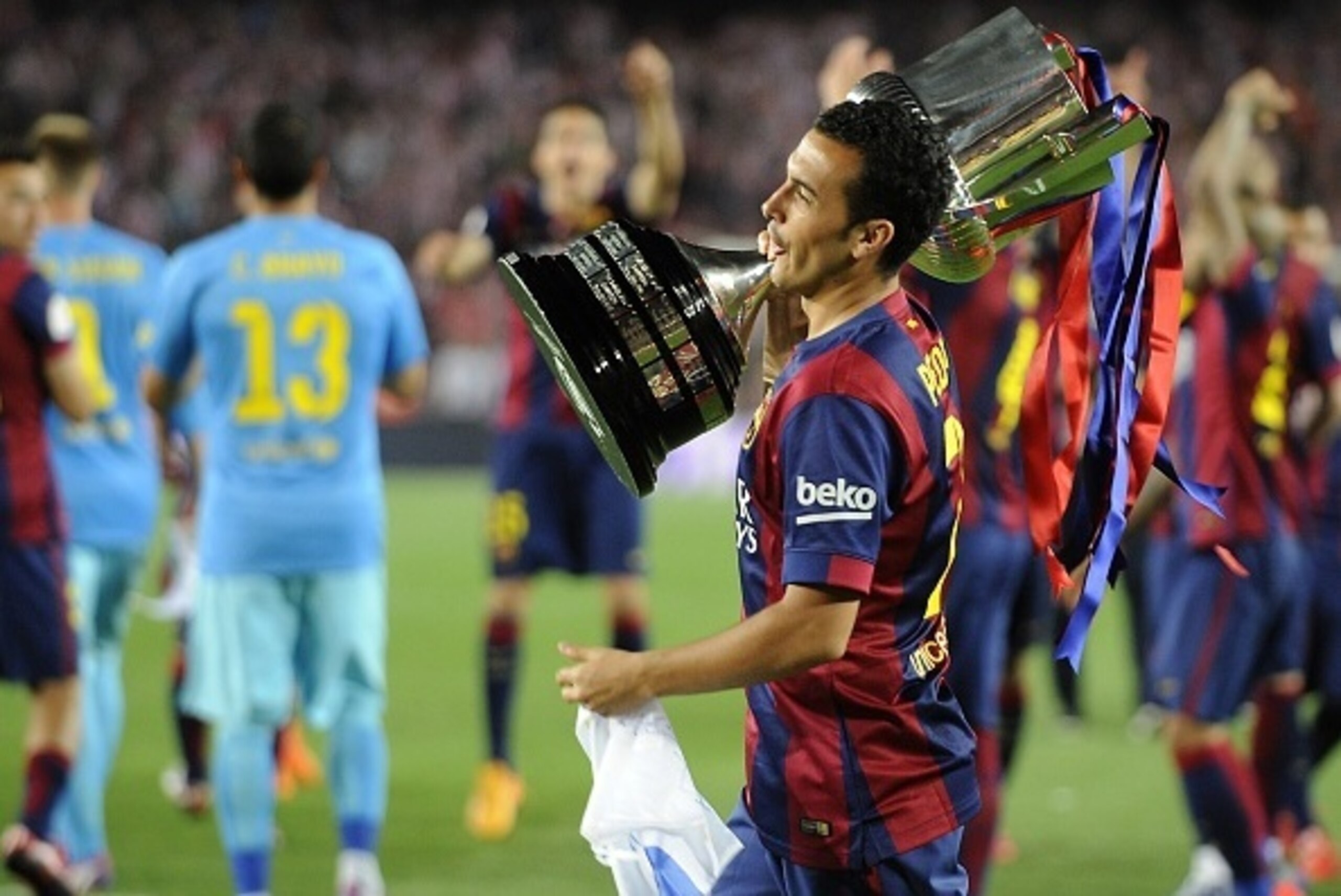 Barcelona's forward Pedro Rodriguez celebrates with the trophy after winning the Spanish Copa del Rey (King's Cup) final football match Athletic Club Bilbao vs FC Barcelona at the Camp Nou stadium in Barcelona on May 30, 2015. Barcelona won 3-1.  AFP PHOT