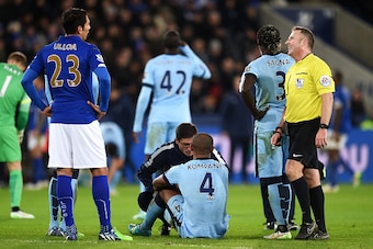 LEICESTER, ENGLAND - DECEMBER 13:  Vincent Kompany of Manchester City goes down injured during the Barclays Premier League match between Leicester City and Manchester City at The King Power Stadium on December 13, 2014 in Leicester, England.  (Photo by Mi