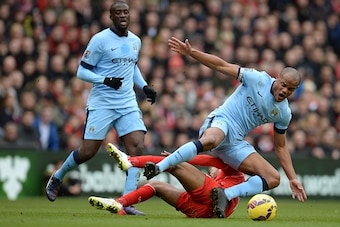 Liverpool's English midfielder Raheem Sterling vies with Manchester City's Belgian defender Vincent Kompany (R) during the English Premier League football match between Liverpool and Manchester City at the Anfield stadium in Liverpool, north west England,
