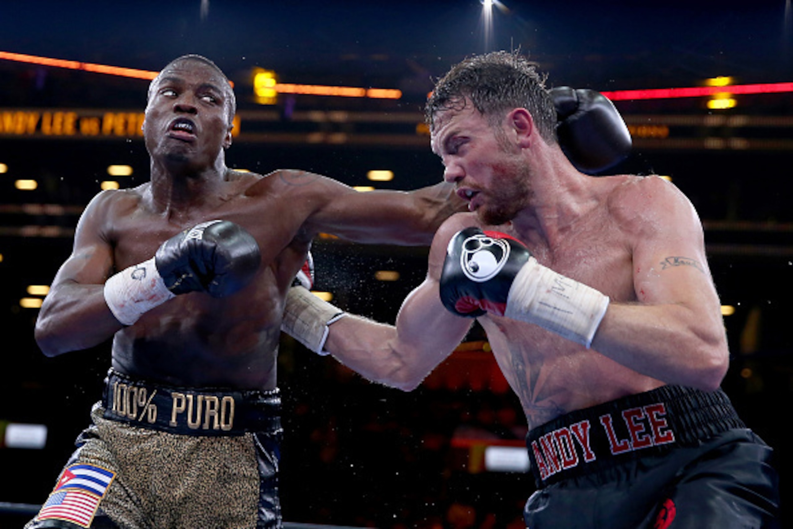 NEW YORK, NY - APRIL 11:  Peter Quillin and Andy Lee exchange punches during the Premier Boxing Champions Middleweight bout at Barclays Center on April 11, 2015 in the Brooklyn borough of New York City.  (Photo by Elsa/Getty Images)