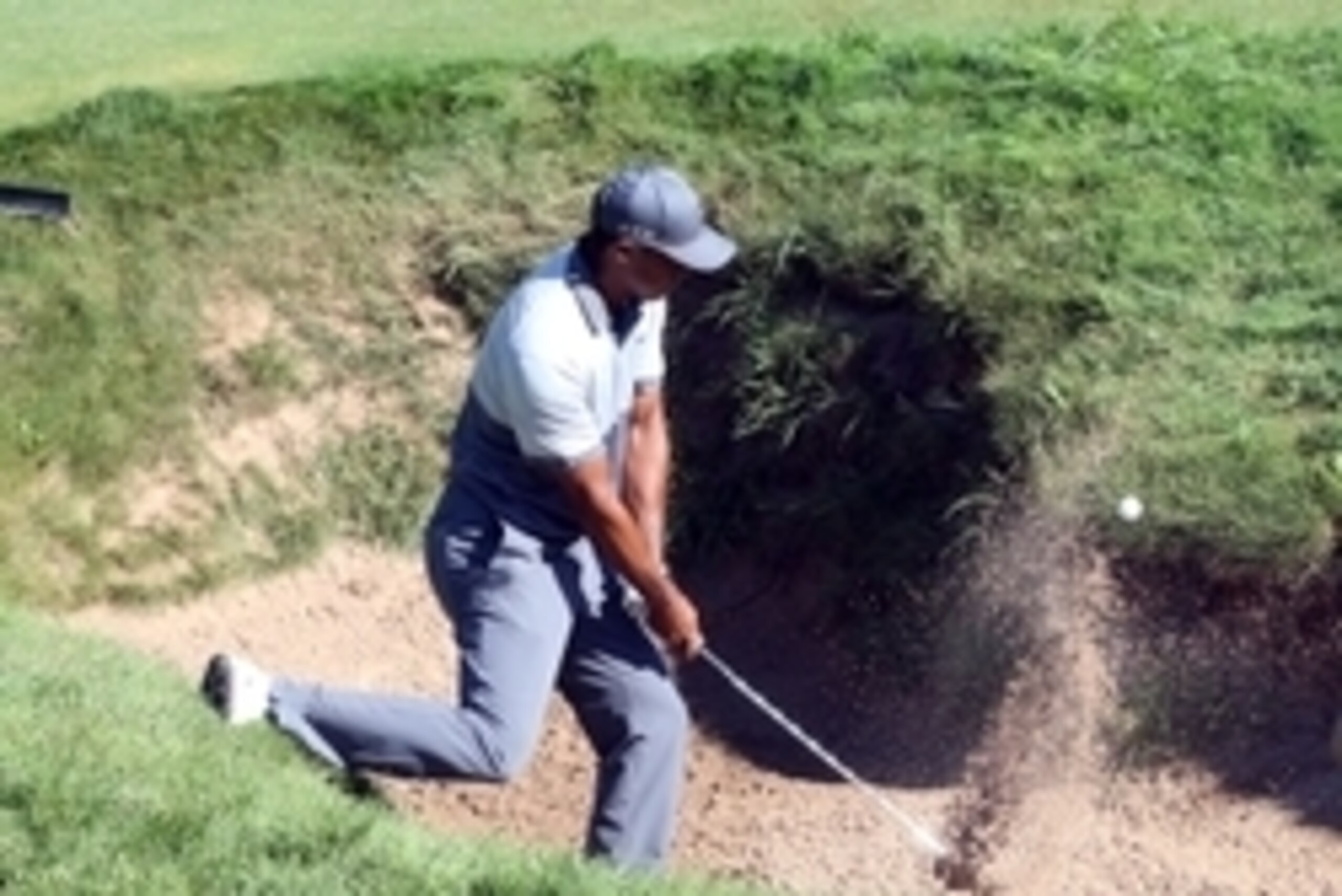 Aug 11, 2015; Sheboygan, WI, USA; Tiger Woods hits out of a bunker on the 9th hole during a practice round for the 2015 PGA Championship golf tournament at Whistling Straits -The Straits Course. Mandatory Credit: Brian Spurlock-USA TODAY Sports