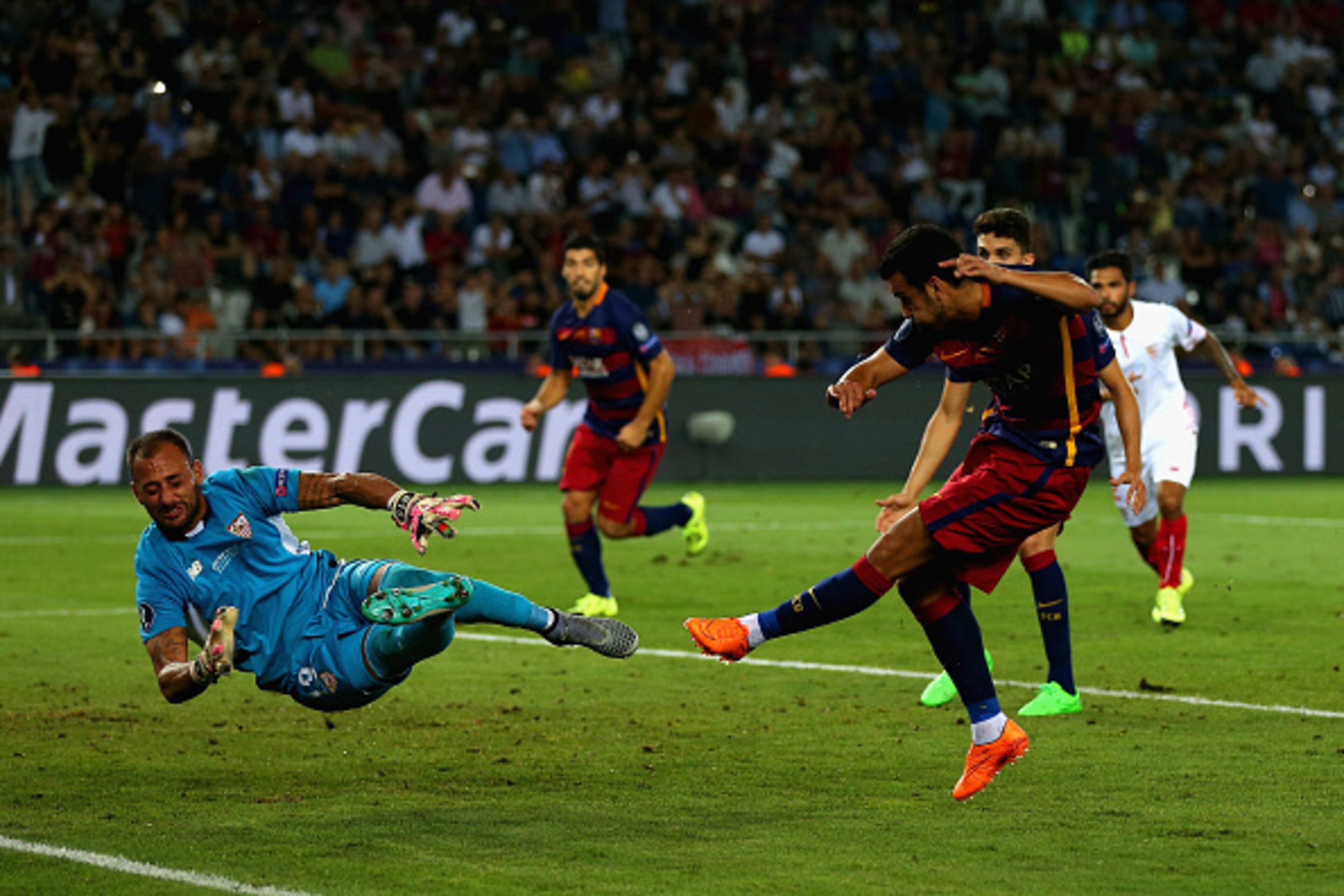 TBILISI, GEORGIA - AUGUST 11:  Pedro of Barcelona scores their fifth goal past Beto of Sevilla in extra time during the UEFA Super Cup between Barcelona and Sevilla FC at Dinamo Arena on August 11, 2015 in Tbilisi, Georgia.  (Photo by Chris Brunskill/Gett