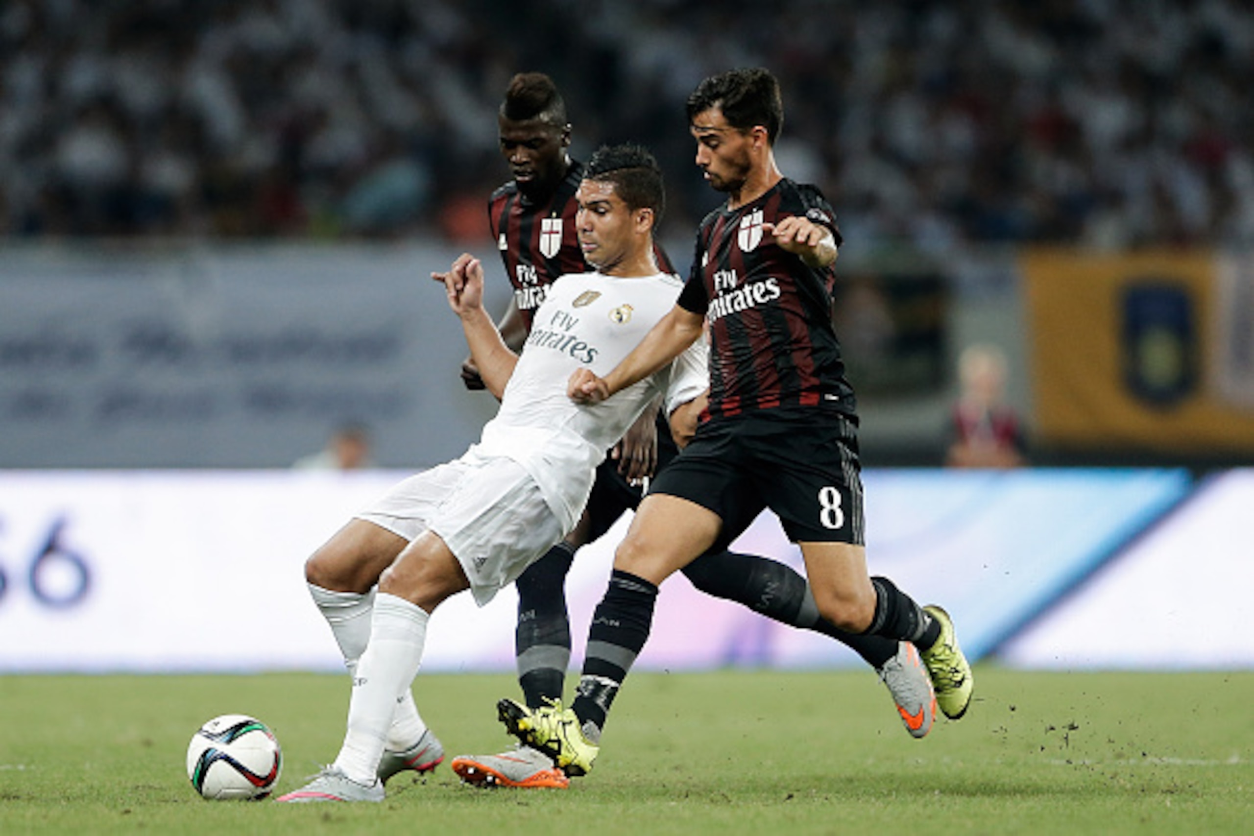 SHANGHAI, CHINA - JULY 30:  Casemiro (C) of Real Madrid contests the ball against Suso (R) and Niang M'baye Hamady of AC Milan during the International Champions Cup match between Real Madrid and AC Milan at Shanghai Stadium on July 30, 2015 in Shanghai, 