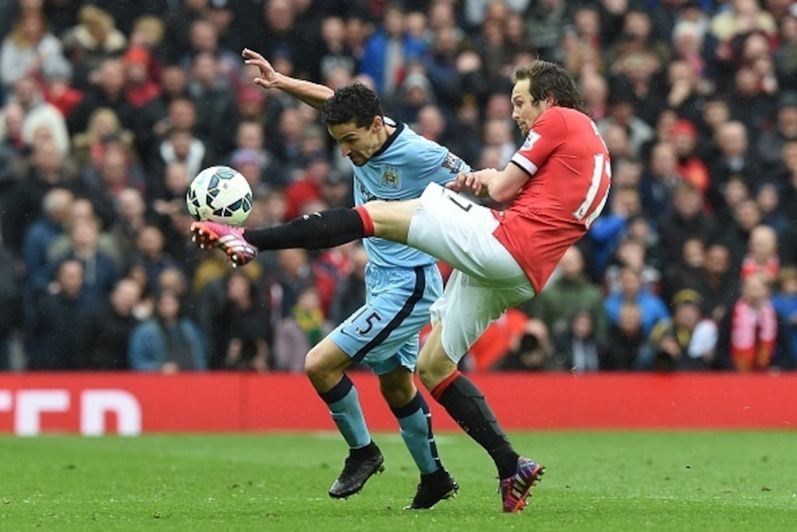 Manchester United's Dutch midfielder Daley Blind (R) vies with Manchester City's Spanish midfielder Jesus Navas (L) during the English Premier League football match between Manchester United and Manchester City at Old Trafford in Manchester, north west En