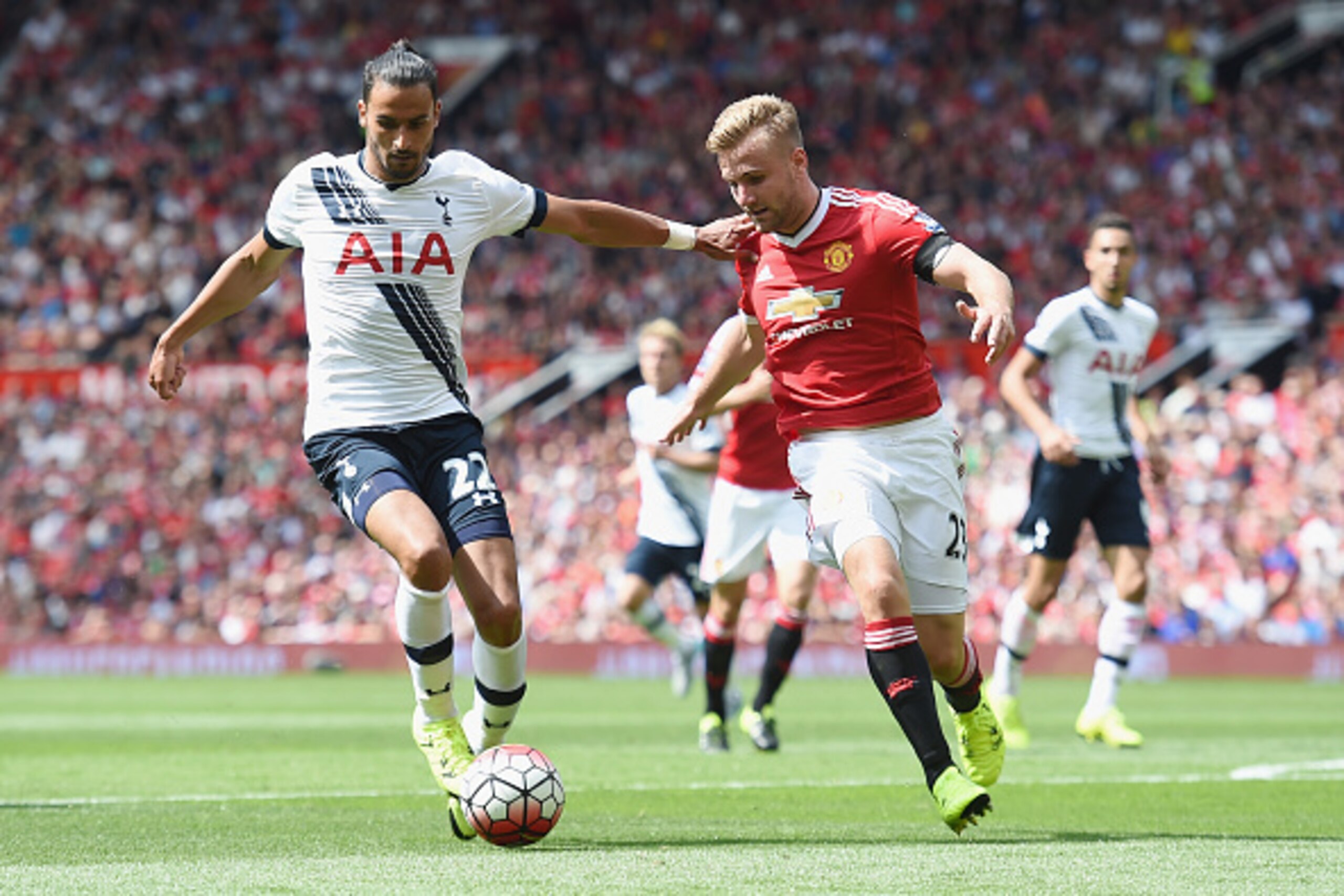 MANCHESTER, ENGLAND - AUGUST 08: Nacer Chadli of Tottenham in action with Luke Shaw of Manchester United during the Barclays Premier League match between Manchester United and and Tottingham Hotspur at Old Trafford, Manchester.  (Photo by Michael Regan/Ge