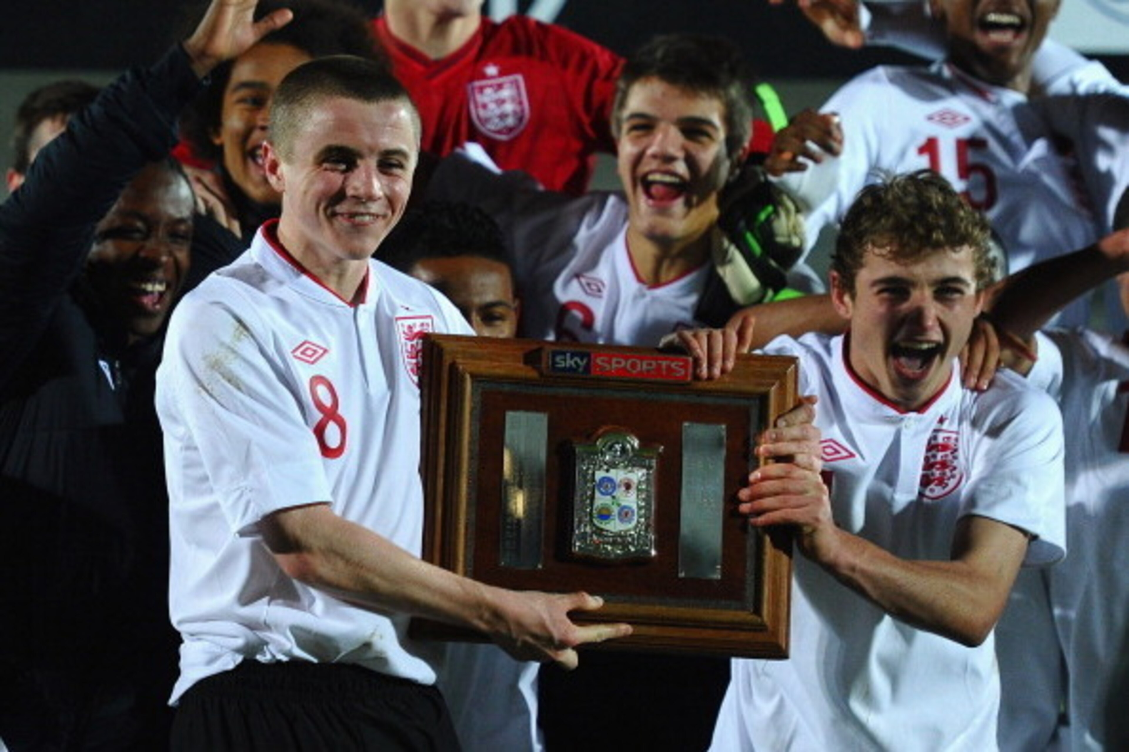 BURTON-UPON-TRENT, ENGLAND - NOVEMBER 29: Jordan Rossiter of England celebrates with the trophy alongside Ryan Ledson after winning the The Sky Sport Victory Shield match between England u16 and Scotland u16 at Pirelli Stadium on November 29, 2012 in Burt