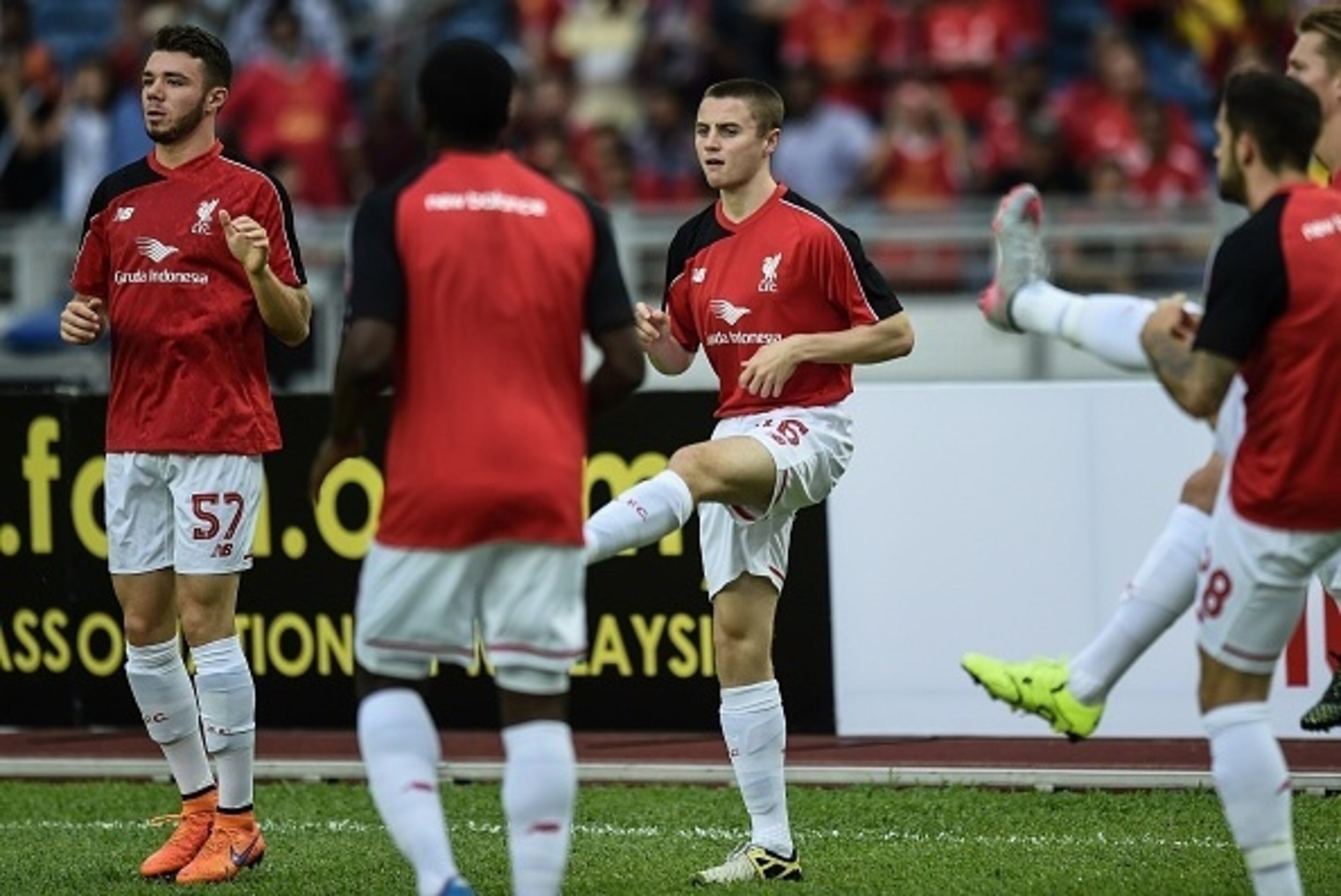 Liverpool's English midfielder Jordan Rossiter (C) warms up with teammates during a training session at the Bukit Jalil Stadium in Kuala Lumpur on July 23, 2015 on the eve of their friendly football match against Malaysia XI.     AFP PHOTO / MANAN VATSYAY